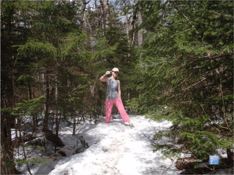 Hiking through snow on the Greeley Ponds trail in the White Mountains of New Hampshire 