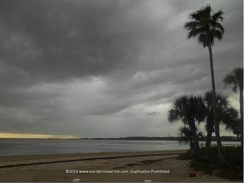 Dark storm clouds and palm trees at Sunset Beach in Tarpon Springs, Florida 