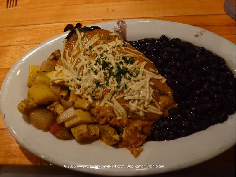 The Southwestern Stuffed Pepper (available gluten-free) is a poblano pepper filled with brown rice, corn, peas, tempeh, and cilantro, served with your choice of sauce and topped with regular or Daiya cheese. This tasty dish is served with black beans and sauteed squash.