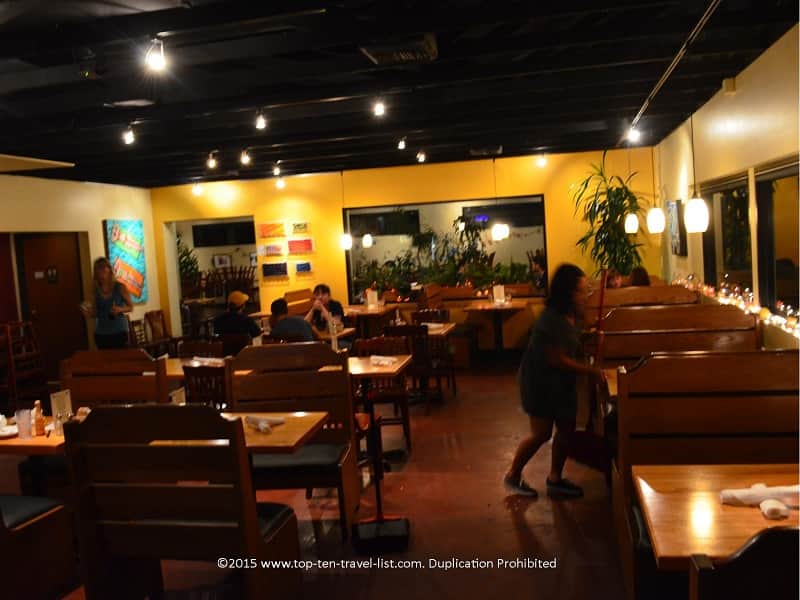 The restaurant is big, bright, and features lots of plants.