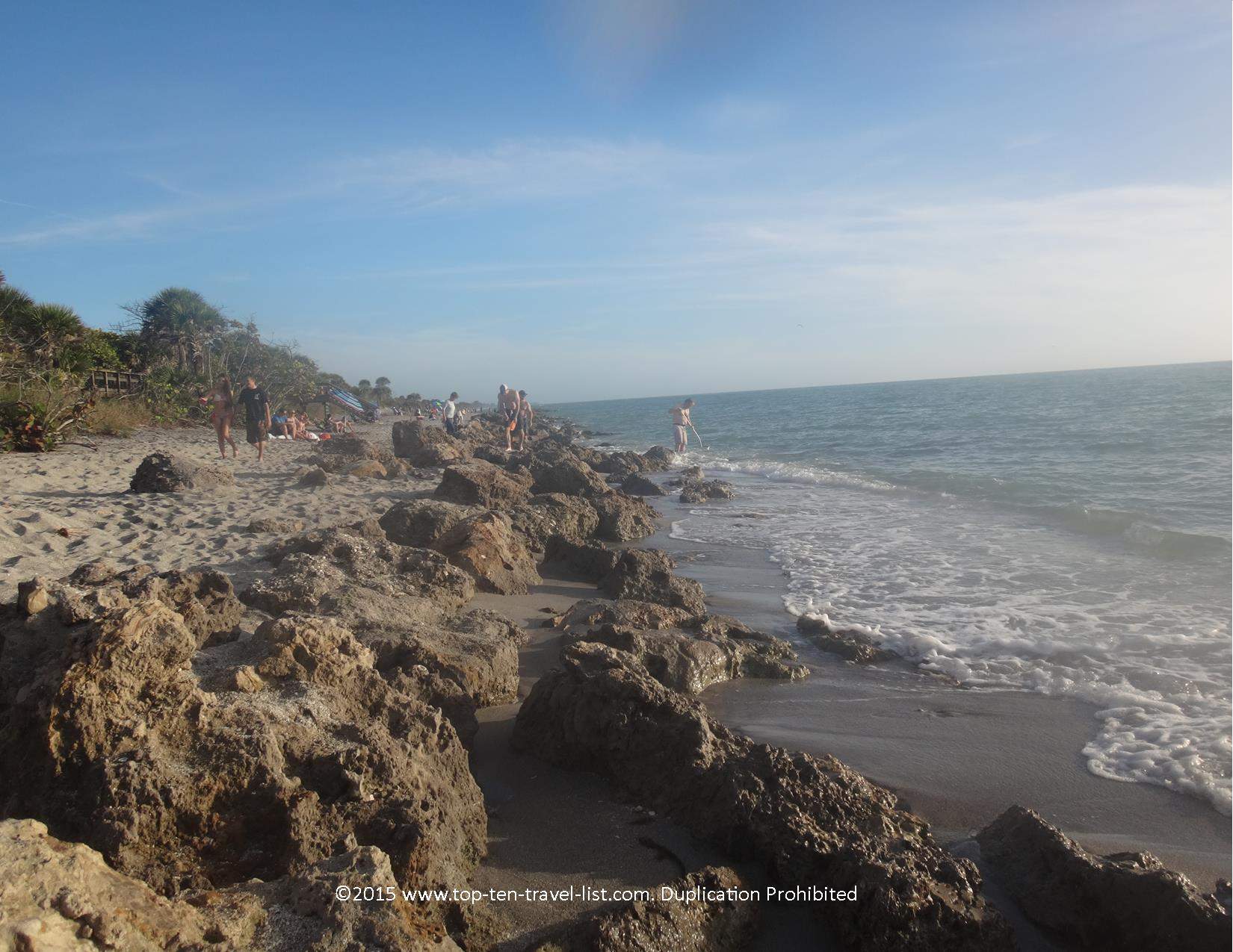 Beach goers seeking shark teeth at Casperan Beach in Venice, Florida 