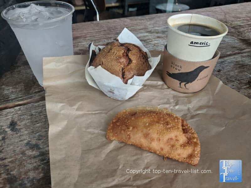Vegan muffin, mac and cheese empanada, and Americano at The Black Crow coffeeshop in St. Petersburg, Florida 