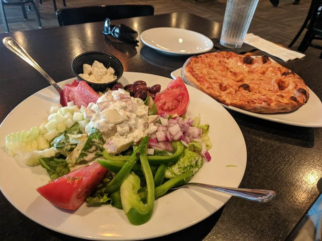 Greek salad and pizza at Slyce