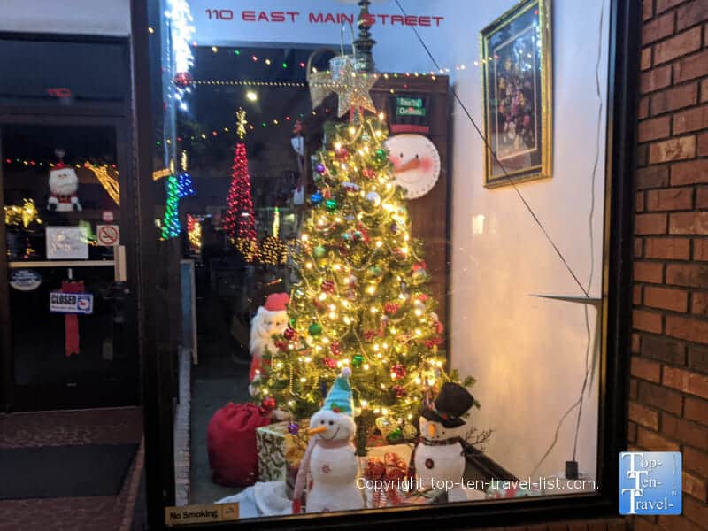 Christmas tree and snowman window display on Main Street in Forest City