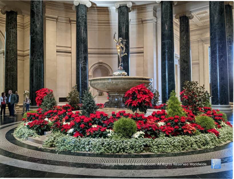 Beautiful fountain with poinsettias at The National Gallery of Art in DC