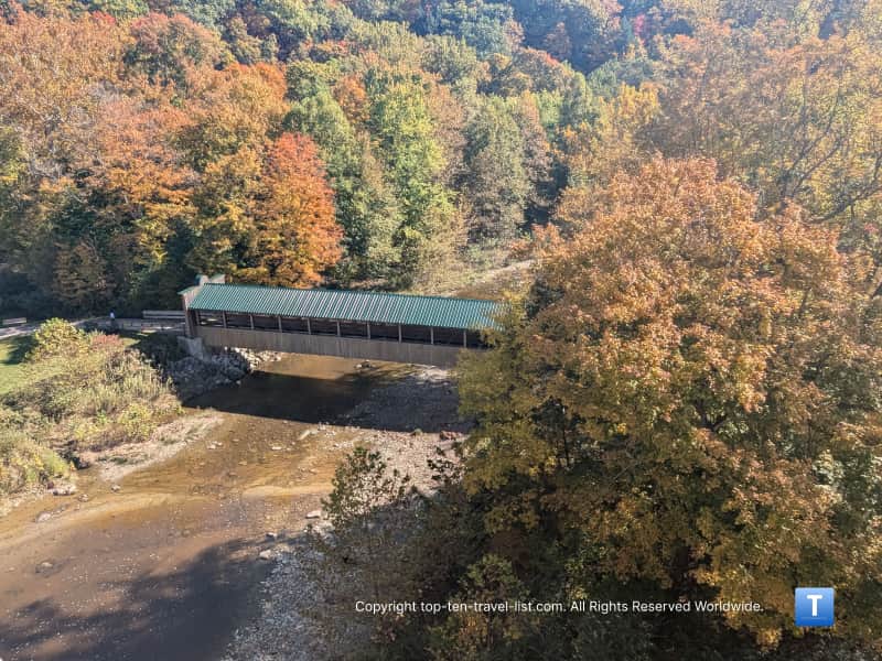 fall foliage surrounding Riverview covered bridge in Ohio