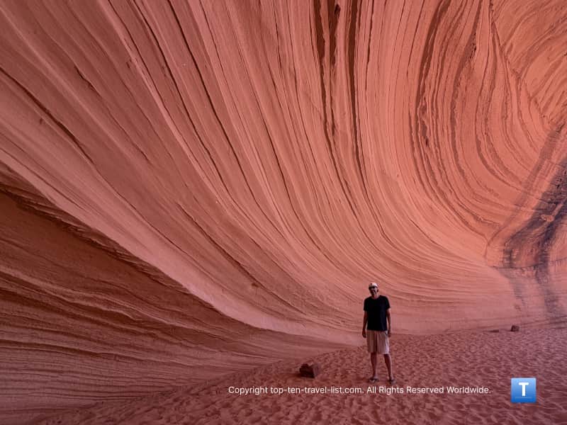 Cool picture by a wavy sandstone wall at Biidi the Arch in Page